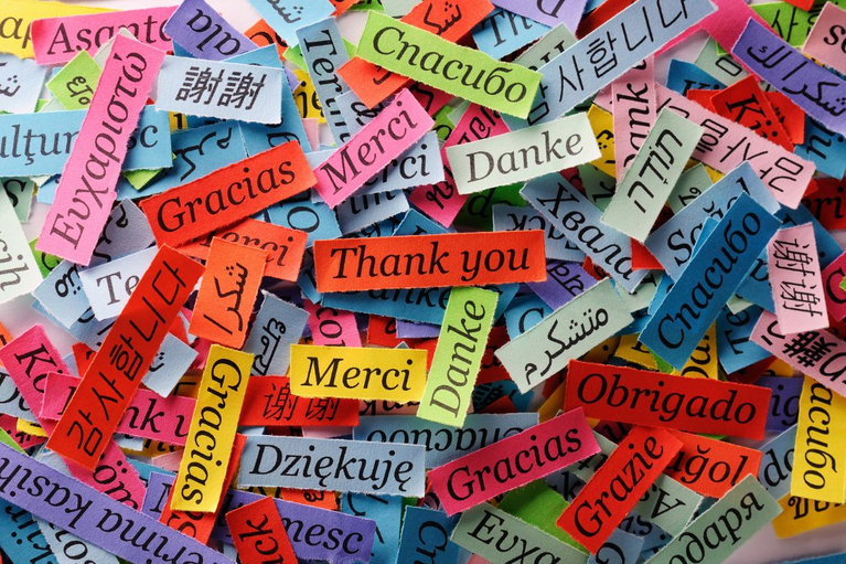 'Thank you' written in different languages on pieces of paper