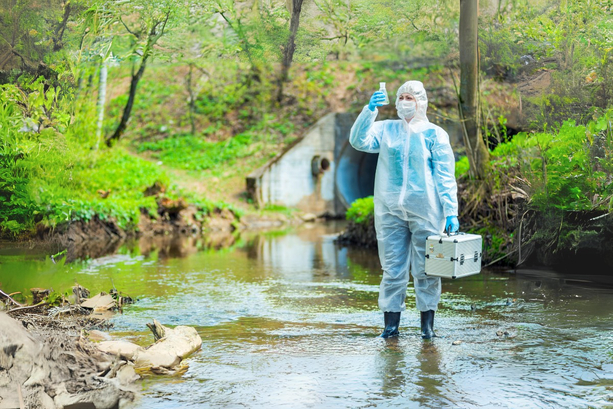 Woman taking a water sample in a river